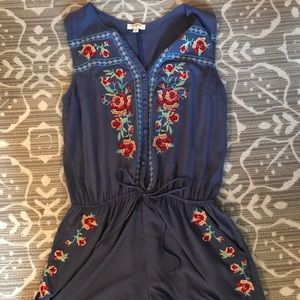 Blue romper with embroidered flowers